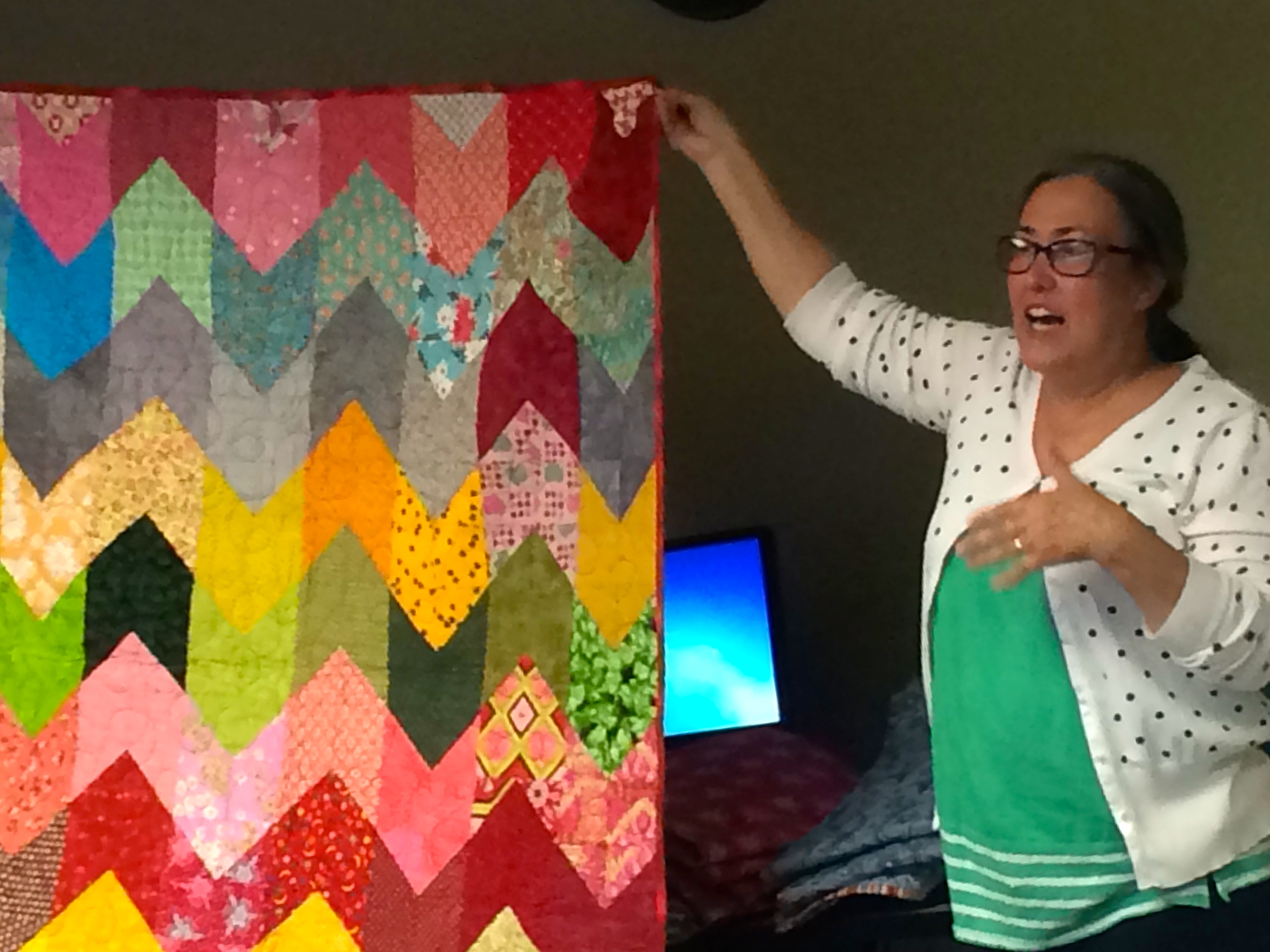 Judy Gauthier and her quilt from her book