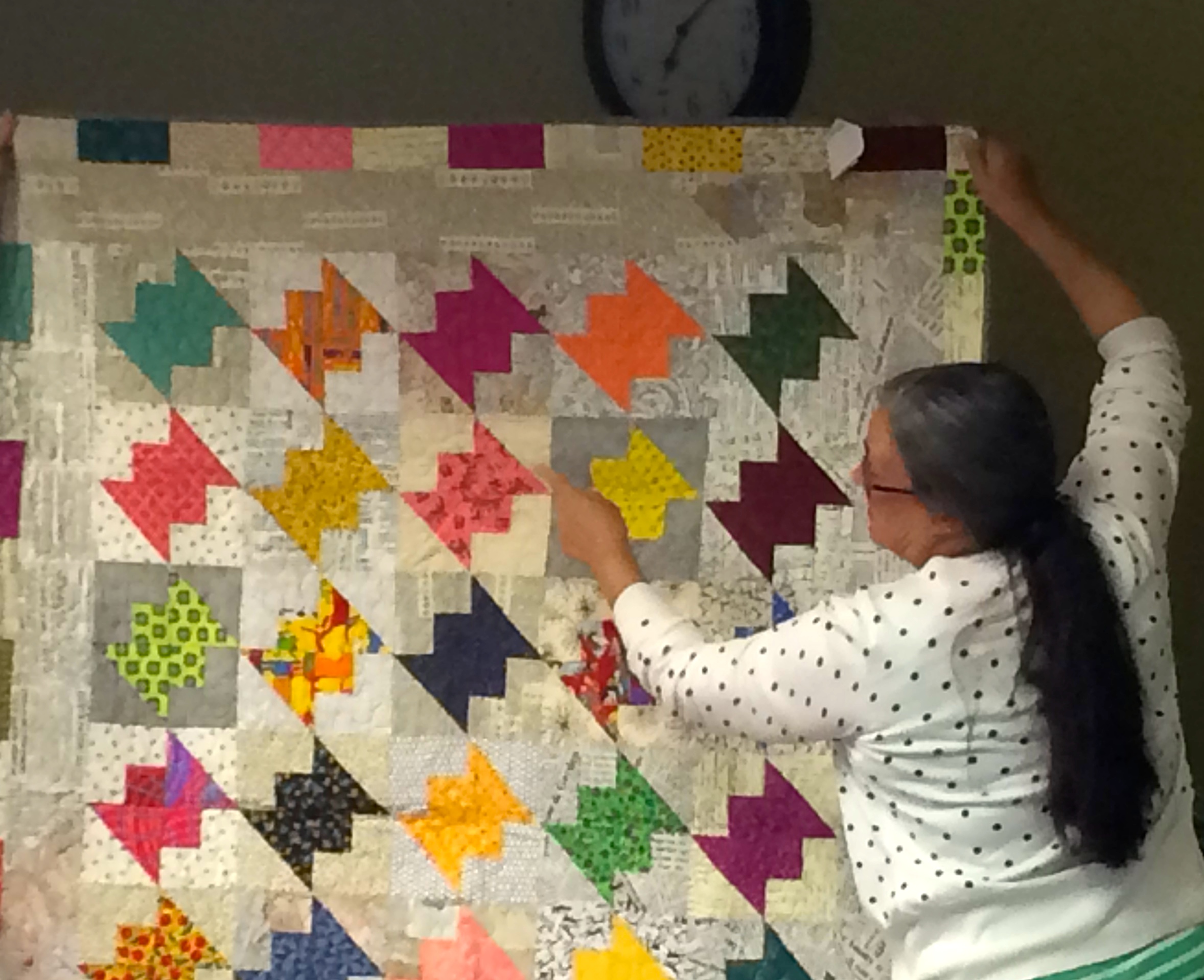 Judy Gauthier and her quilt from her book