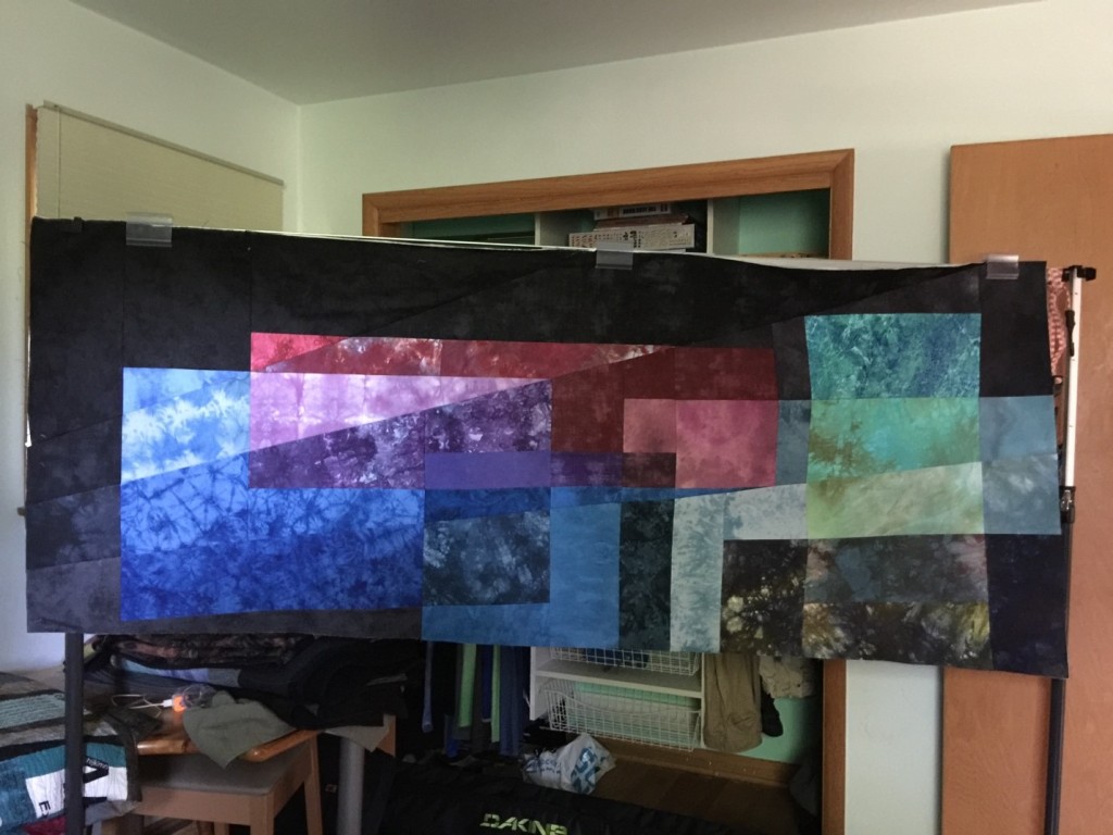 Quilt display stand used as a design wall – quilt with 3 of 8 rays assembled