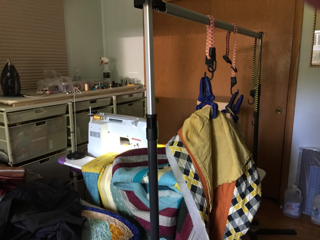 Quilt display stand used to suspend quilt during the quilting process.  The display stand is easily located to the side, front, or back whichever is most convenient for working on a specific part of the project.  Easy to move is very beneficial.